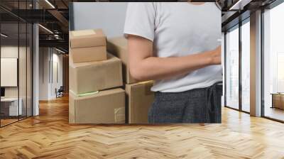 Small Asian business owner packing in the cardbox preparing parcel for delivery online selling sell Online on the Internet from home Wall mural